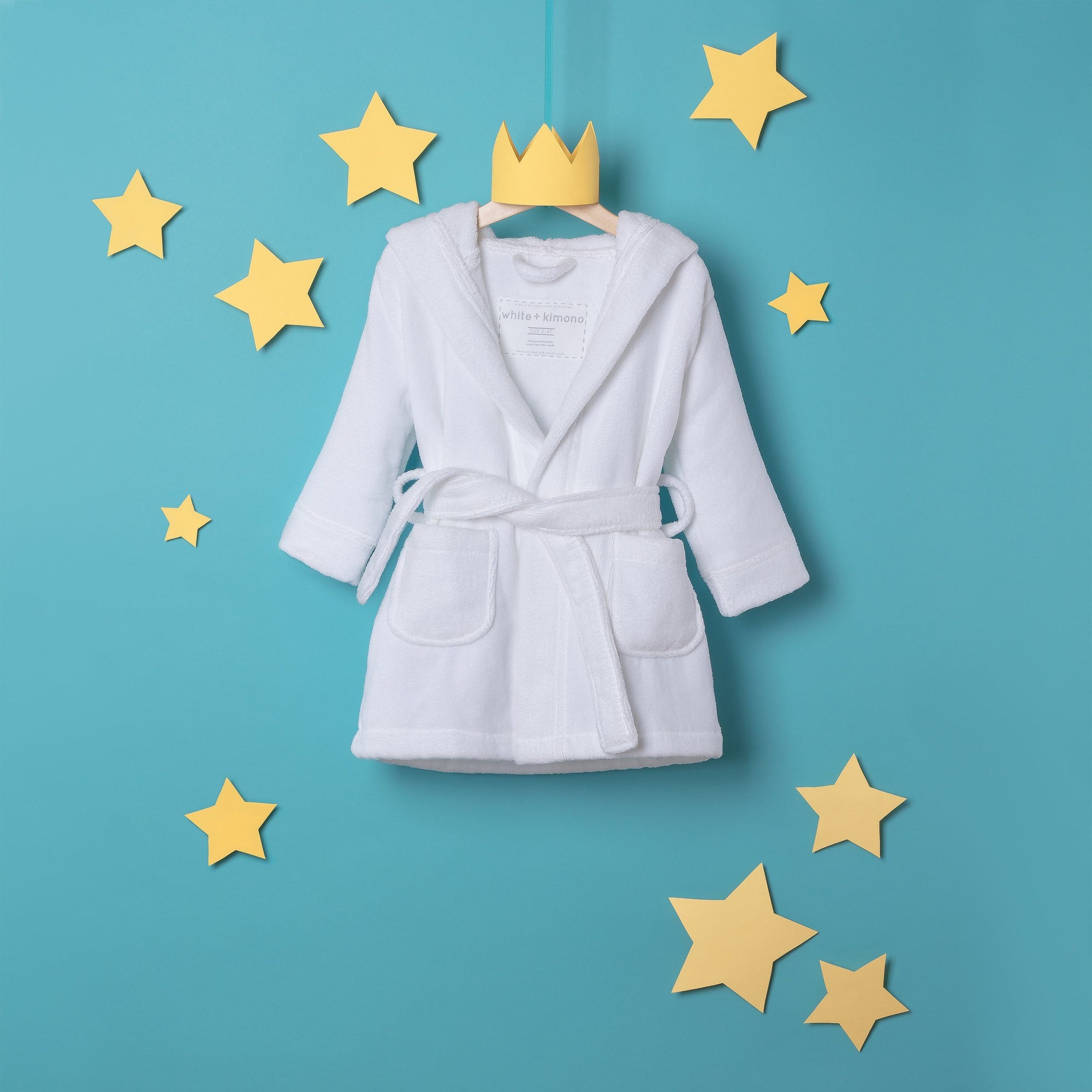 Image of white cotton bathrobe hanging with stars (front view)